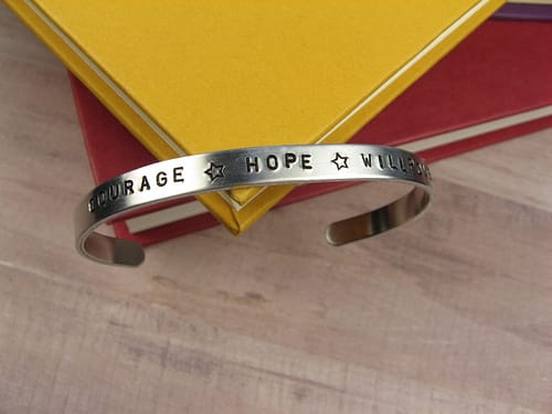 Custom bracelet that says courage, hope, and willpower.