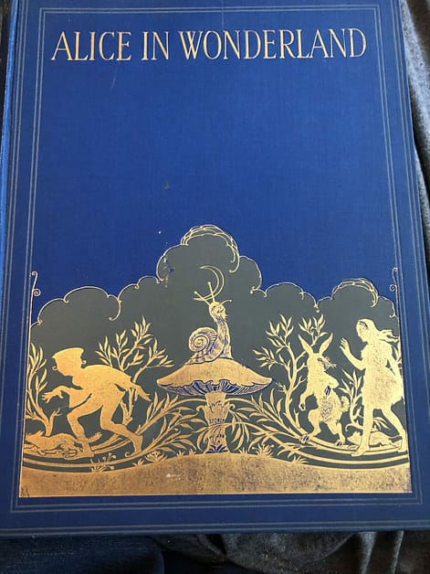 Blue and gold book cover for Alice in Wonderland